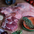 Butterfly Leg of Lamb with herbs and spices on a wooden surface