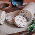 Fruit Pudding slices on a wooden board with herbs