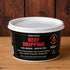 A 500g tub of Traditional Beef Dripping on a wooden surface with a dark wood background. The tub has a white lid and a black label with red and white text.