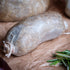 Baby haggis on brown paper with rosemary and a red pepper.