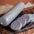 Haggis Slices on a wooden cutting board with a knife