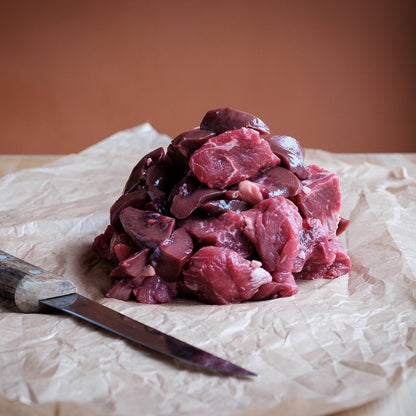 Raw steak &amp; kidney on a wooden surface with a knife
